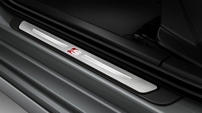 Illuminated door sill trims with aluminium inlays and S logo